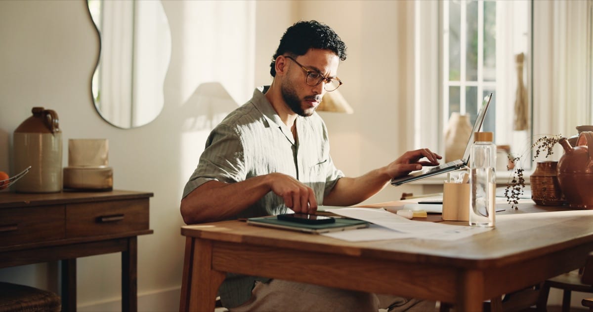 Entrepreneur working from home office with laptop and tablet